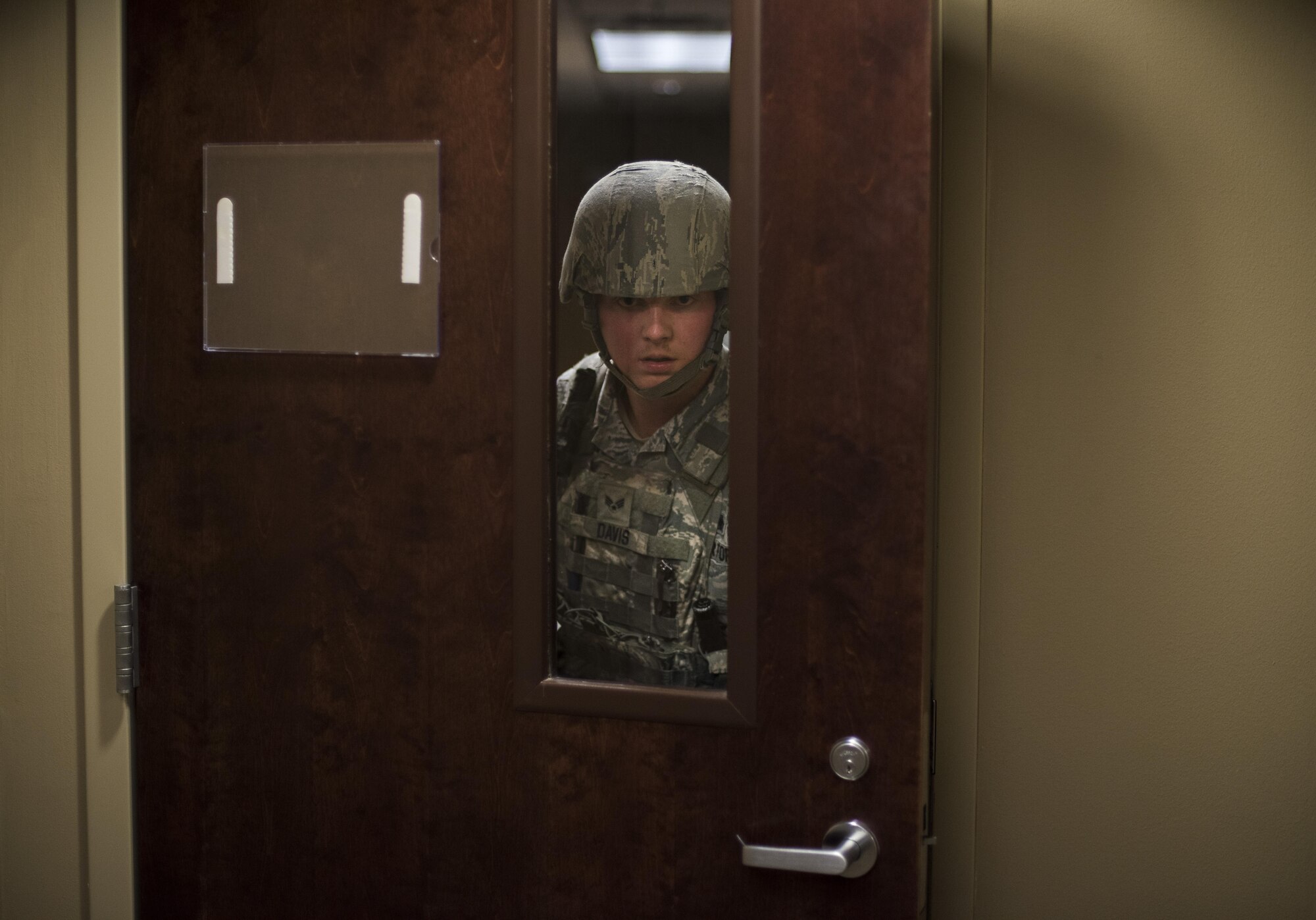Senior Airman Alexander Davis, 2nd Security Forces Squadron patrolman, searches rooms for victims and potential threats during an active shooter exercise at Barksdale Air Force Base, La., Nov. 29, 2016.  Exercises allow the commander to see exactly what areas need more focus and training, and a means to enhance readiness, boost capabilities and streamline procedures in the event of a major incident. (U.S. Air Force photo/Senior Airman Damon Kasberg)