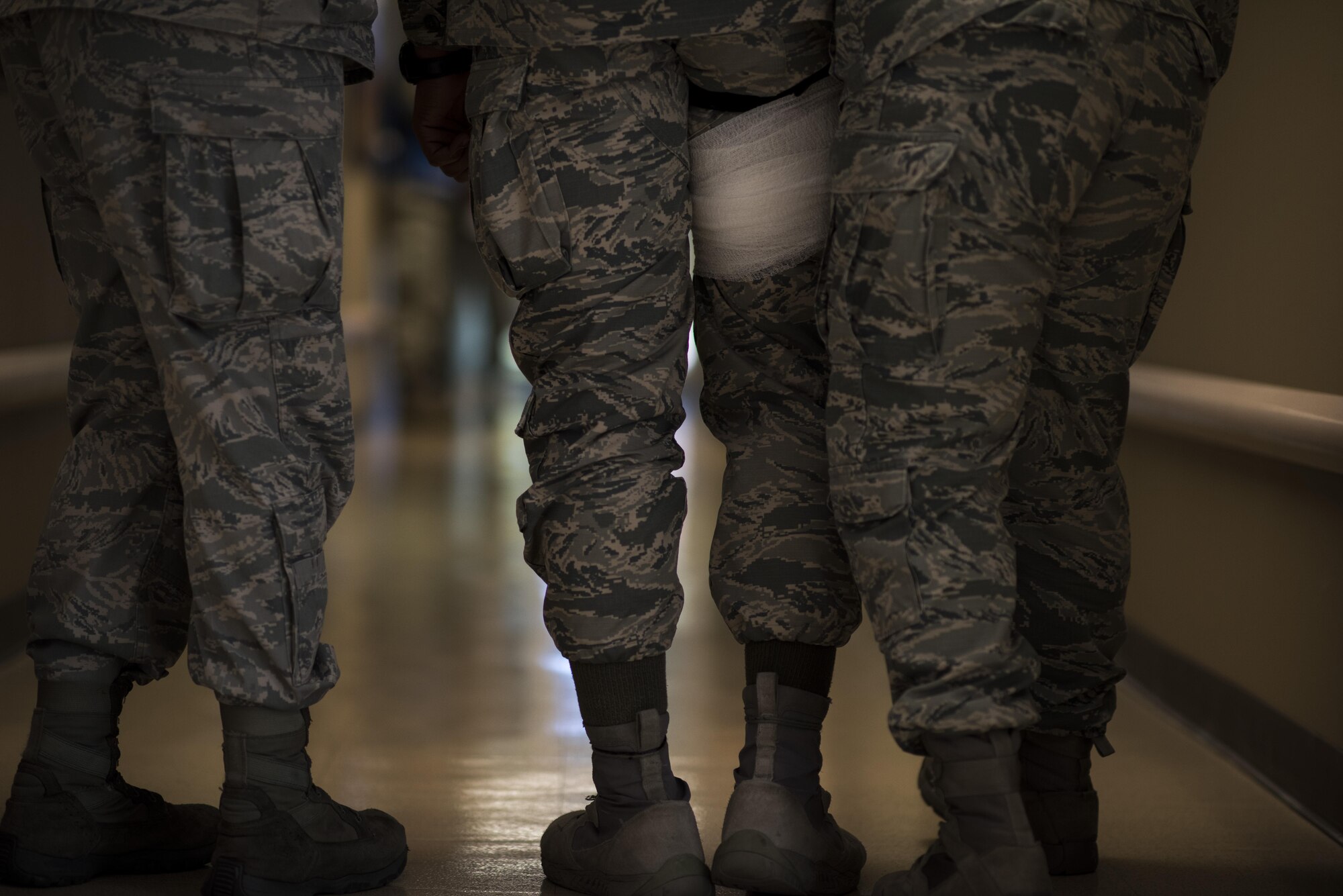 Airmen assist a simulated victim evacuate a building during an active shooter exercise on Barksdale Air Force Base, La., Nov. 29, 2016. Exercises allow the commander to see exactly what areas need more focus and training, and a means to enhance readiness, boost capabilities and streamline procedures in the event of a major incident. (U.S. Air Force photo/Senior Airman Damon Kasberg)