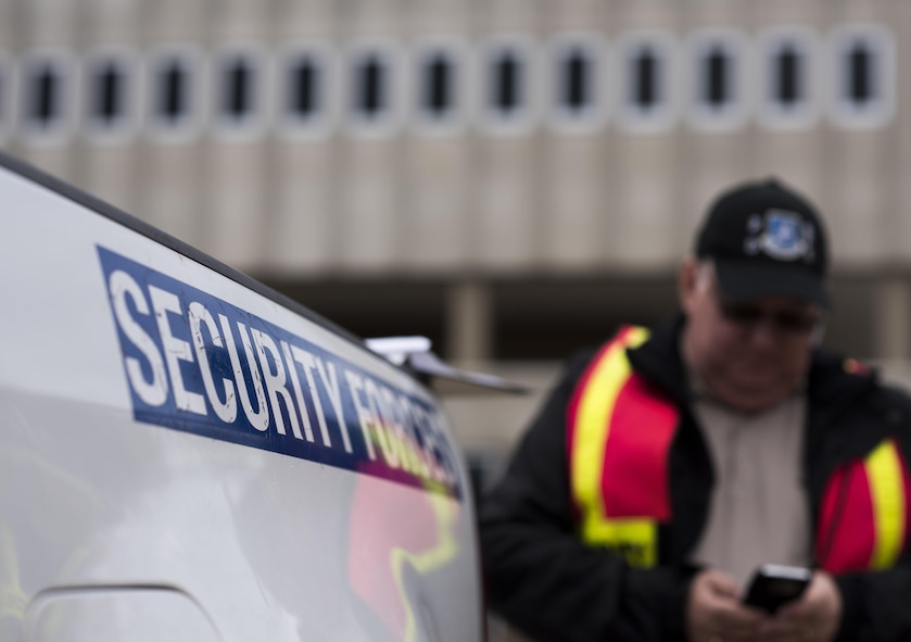 A member of the inspection team checks his cell phone for updates during an active shooter exercise on Barksdale Air Force Base, La., 29, 2016. Exercises give the wing commander a means to enhance readiness, boost capabilities and streamline procedures in the event of a base emergency. (U.S. Air Force photo/Senior Airman Damon Kasberg)