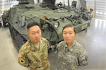 Pfc. Sam and Pvt. Jennifer Mei, both Pennsylvannia National Guard members, pose in front of a Stryker armored fighting vehicle at the Ordnance School Nov. 17, 2016. Sam graduated from the17-week  course Nov. 22.  Jennifer is scheduled to complete the course in March.  Another sibling, Milton, 19, is also undergoing training at Fort Lee. 