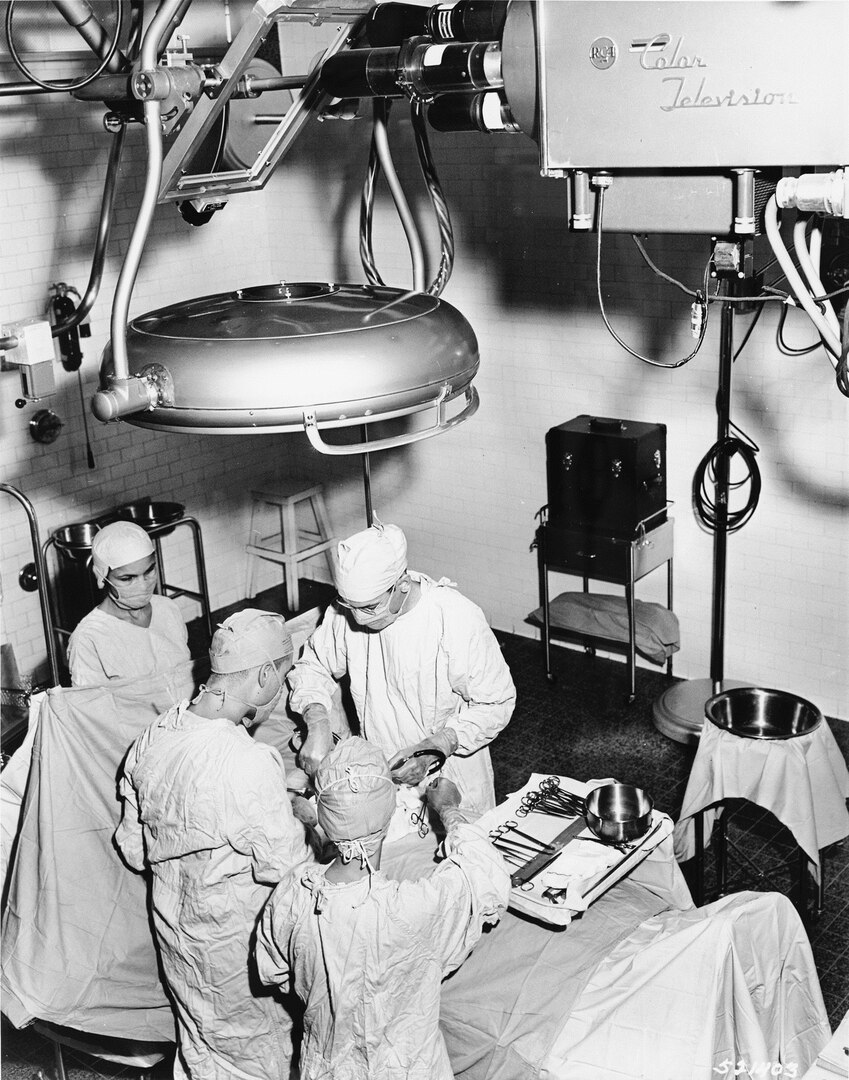 Color television cameras first entered the operating rooms of Walter Reed Army Medical Center, or WRAMC, which was then located in Washington, D.C., in 1957. The camera is trained on the surface of a mirror suspended at an angle above the operating table. 