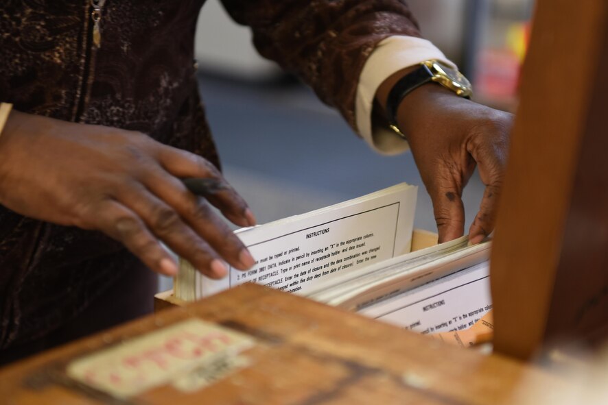 Sharron Jackson, 2nd Communications Squadron contract site manager, checks a file to find an Airman’s mailbox number at Barksdale Air Force Base, La., Dec. 7, 2016. The postal service center receives, separates and distributes mail to Airmen living in the dormitories. (U.S. Air Force photo/Airman 1st Class Alexis C. Schultz)