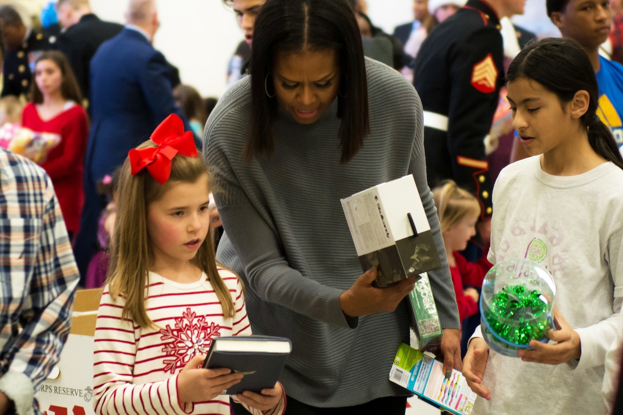 First Lady Michelle Obama helps Lauren Gordon, 9,  figure out where to put a toy during the Toys for Tots event at Joint Base Anacostia-Bolling, Washington, D.C., Dec. 7, 2016. DoD photo by Scott Pauley