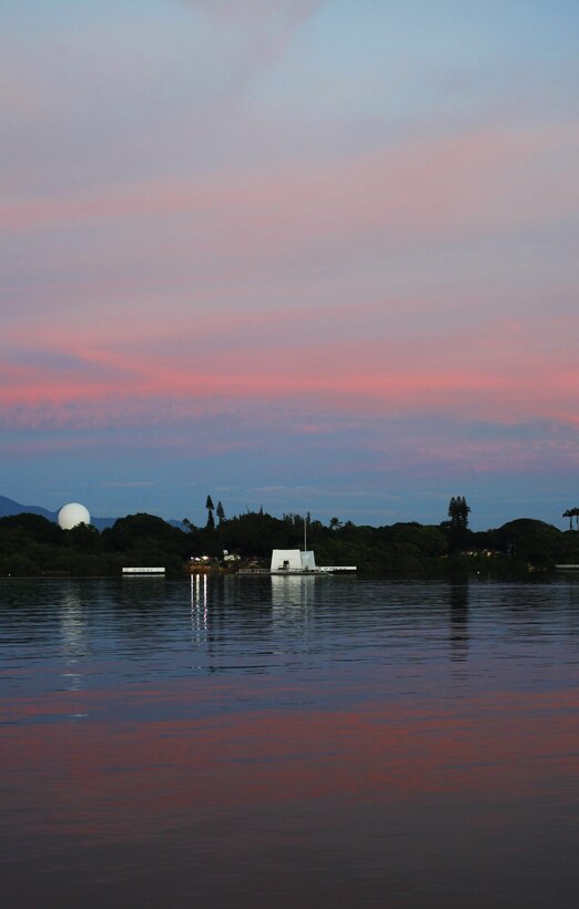 The USS Arizona Memorial is illuminated by the rising sun during the 75th National Pearl Harbor Remembrance Day Commemoration Ceremony at Joint Base Pearl Harbor-Hickam, Hawaii, Dec. 7, 2016. Civilians, veterans, and service members came together to remember and pay their respect to those who fought and lost their lives during the attack on Pearl Harbor. ( U.S. Marine Corps Photo by Lance Cpl. Patrick Mahoney)