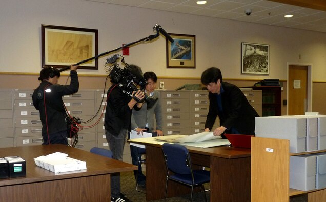 A documentary film crew from the Japanese Broadcasting Corporation, Nippon Hoso Kyokai reviews unclassified archives from the Air Force Heritage Research Center for their newest documentary, Dec. 5, 2016, Maxwell Air Force Base, Ala. The crew visited the Air Force Historical Research Agency here and gained more insight on why and how decisions were made during the bombings of Japan.( Courtesy photo)