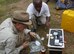 A member of the Ramstein Air Base, Germany, chaper of the Society of American Military Engineers, samples water from a local pond in Uganda. A small group from the chapter, including AFCEC's April Whitbeck, travelled to the African nation to try to set up a system for deliverying clean water to villagers. (Courtesy photo)