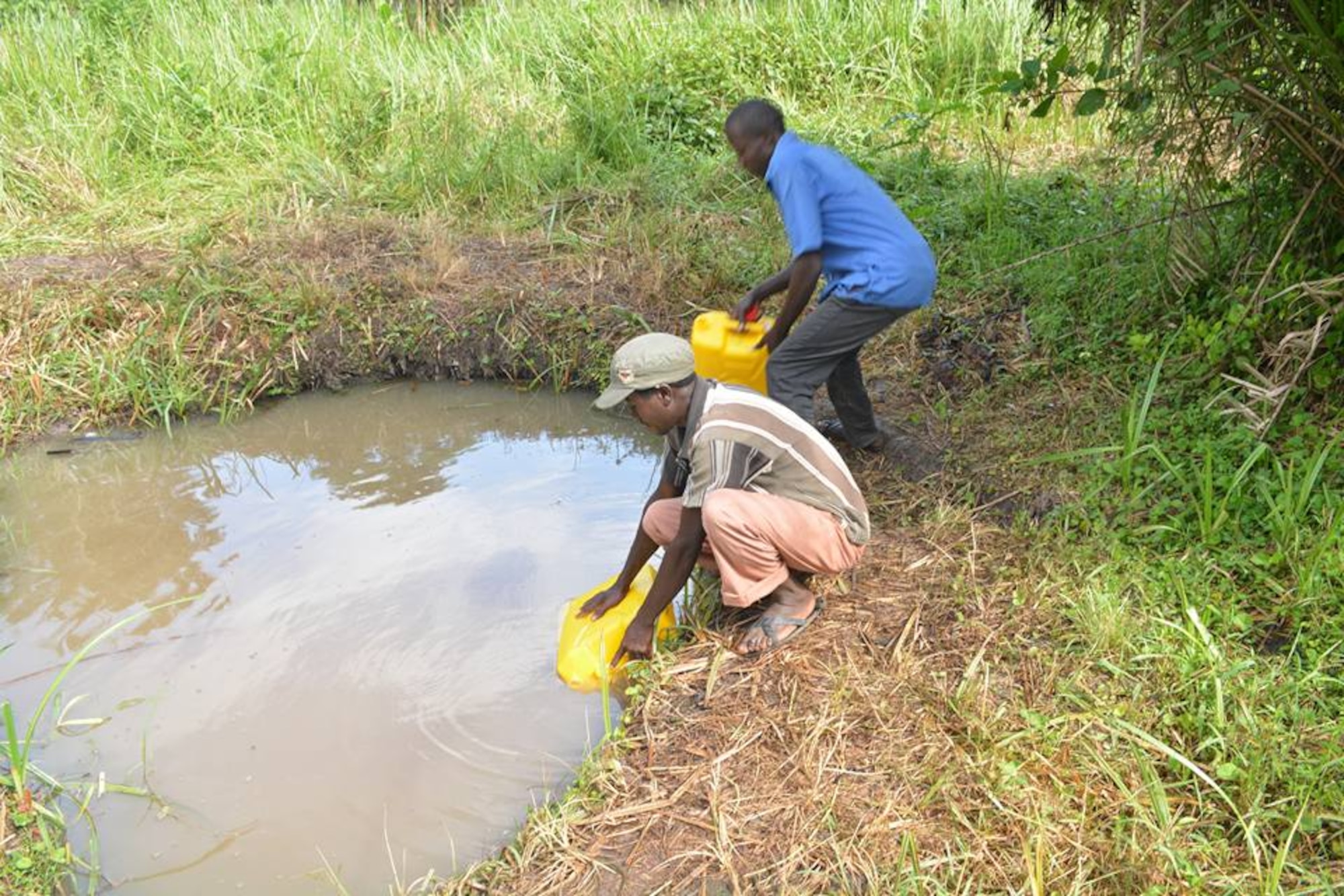 Villagers collect water from a local pond. The water, used for houshold needs such as drinking and cooking, contains bacteria that causes those who consume it to become ill. (Courtesy photo)