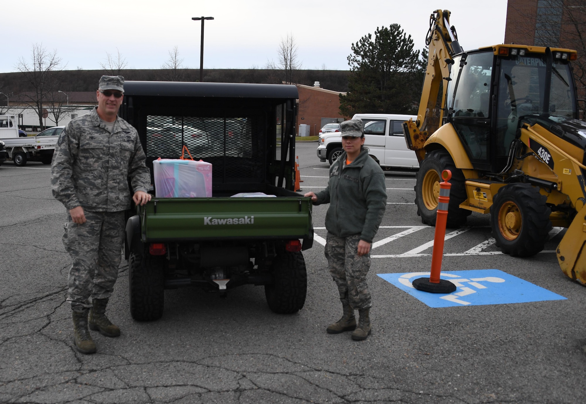 Staff Sgt. Ashley Wiley, aircraft structural maintenance technician and Angel Tree program manager at the 911th Airlift Wing, poses with Senior Master Sgt. John Lee at the Pittsburgh International Airport Air Reserve Station, Dec. 4, 2016. Lee, 911th AW member and coordinator with Heroes Supporting Heroes, dropped off gifts donated by HSH to benefit the families of Airmen in need. (U.S. Air Force photo by Staff Sgt. Marjorie A. Bowlden)
