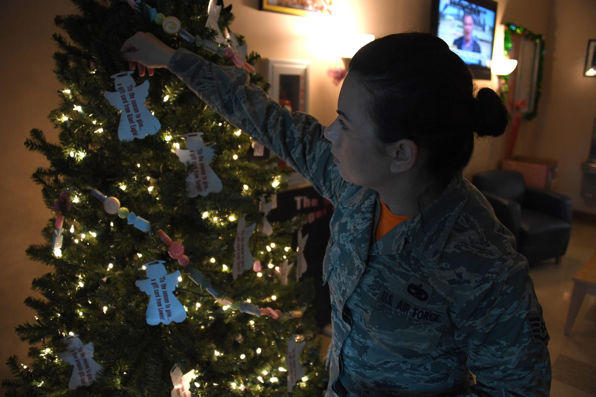 Staff Sgt. Ashley Wiley, aircraft structural maintenance technician and Angel Tree program manager with the 911th Airlift Wing, replaces an ornament on the Angel Tree in the fitness center lobby at the Pittsburgh International Airport Air Reserve Station, Dec. 4, 2016. Wiley has managed the Angel Tree program for three years and has coordinated more than $7,000 in donations for Airmen in need. (U.S. Air Force photo by Staff Sgt. Marjorie A. Bowlden)