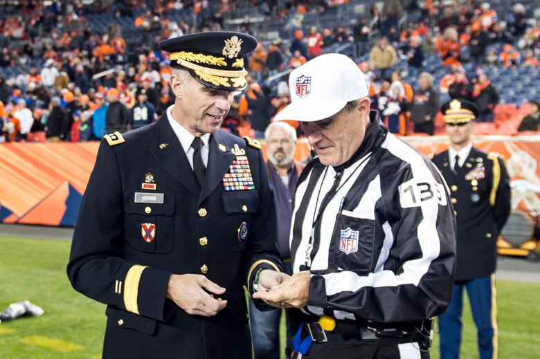 DENVER - U.S. Army Lt. Gen. Reynold Hoover, U.S. Northern Command deputy commander, presents to the head referee the coin used in the opening coin toss for the Salute to Service football game between the Denver Broncos and the Kansas City Chiefs, Nov. 27, 2016, at Sports Authority Field at Mile High in Denver. Hoover also met and helped recognize the service of several Vietnam veterans in attendance. (U.S. Air Force photo by Senior Master Sgt. Chuck Marsh/Released)