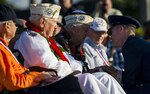 Capt. Kimber Nettis, 515th Air Mobility Operation Wing Cyberspace Operations chief, smiles with Command Sgt. Maj. Armando Galella, a veteran who lost his best friend during the Dec. 7, 1941 attacks on Oahu, during a photo-opportunity session after the 75th Commemoration of the Dec. 7, 1941 attack on Hickam Field ceremony Dec. 7, 2016, at Joint Base Pearl Harbor-Hickam, Hawaii. The attacks on seven bases throughout Oahu precipitated America's entry into World War II, and the annual commemoration ceremony is designed to foster reflection, remembrance, and understanding for those affected by the events that took place 75 years ago.