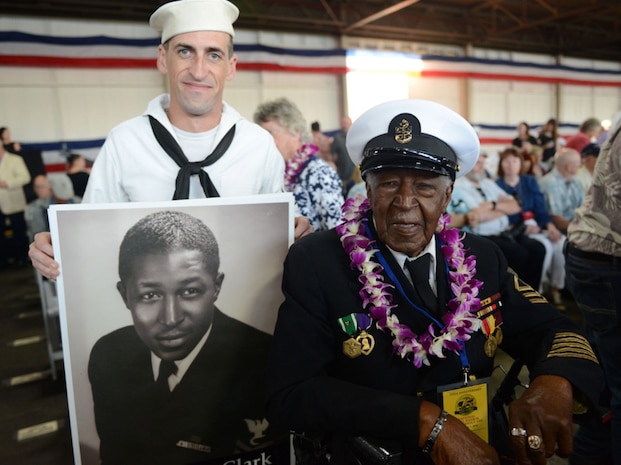 Carl Clark, a Pearl Harbor survivor and retired Navy Chief Petty Officer, smiles for a photo with a Navy sailor at the 75th Commemoration of the attack on Pearl Harbor at Kilo Pier, Joint Base Pearl Harbor-Hickam, Oahu.  Pearl Harbor survivors, World War II veterans, service members, veterans and civilians came together to remember and pay their respect to those who fought and lost their lives during the attack on Pearl Harbor. 
