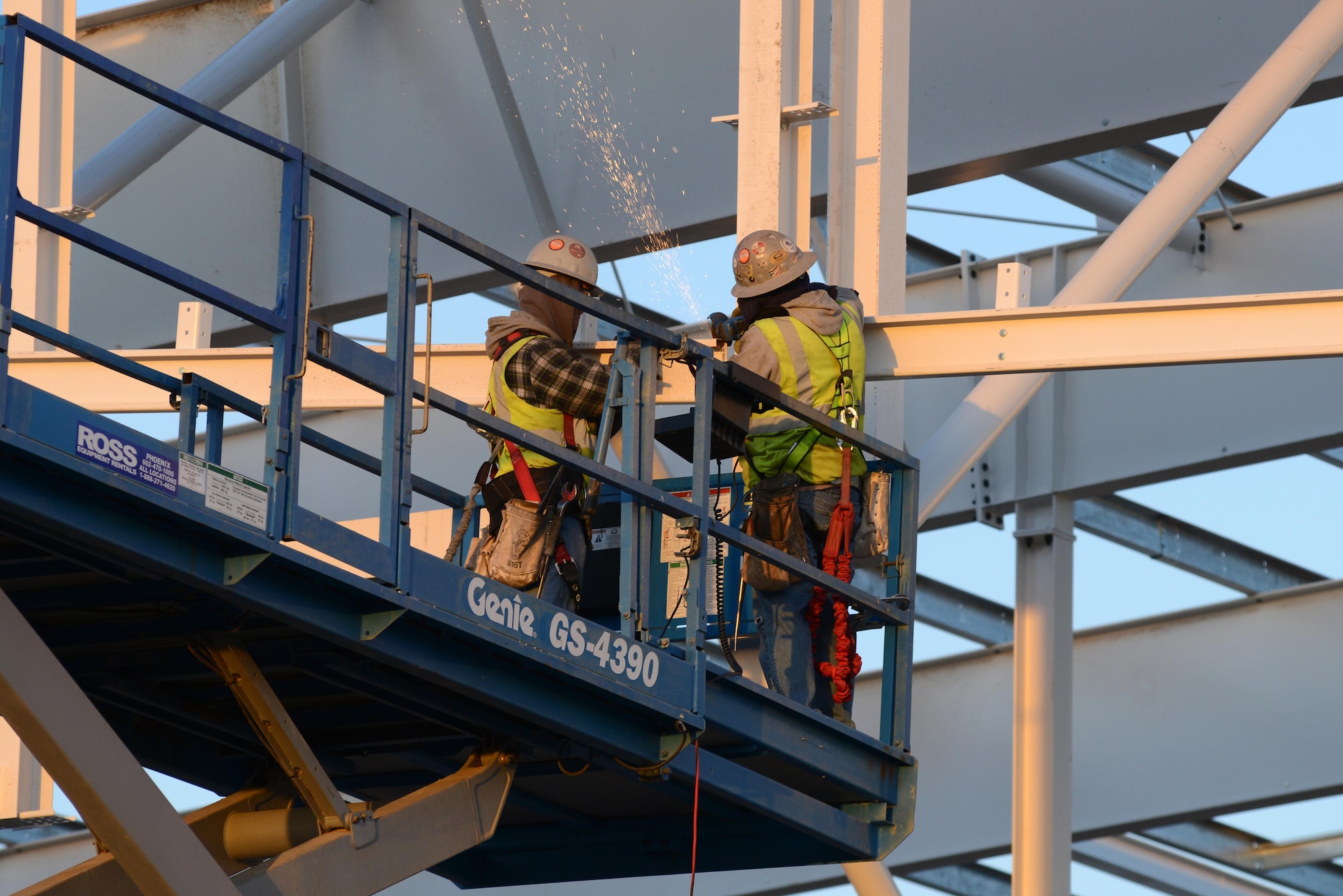 Two 56th Civil Engineering Squadron Korte iron work construction contractors install the overhang on the 62nd Fighter Squadron hangar door Dec. 8, 2016, at Luke Air Force Base, Ariz. The hangar is scheduled to be completed around June 2017.(U.S. Air Force photo by Airman 1st Class Pedro Mota)