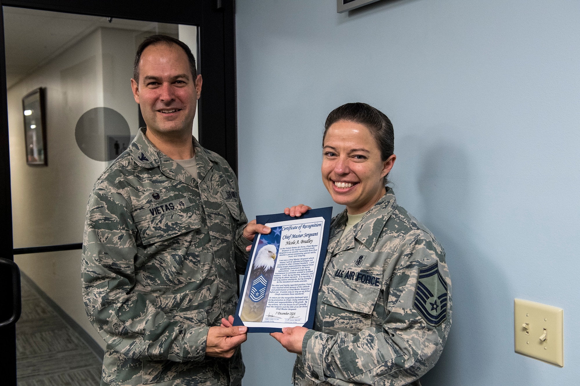 Col. Jay Vietas, 23d Medical Group commander, poses for a photo with Senior Master Sgt. Nicole Bradley, 23d Aerospace Medical Squadron superintendent, after congratulating her on making the rank of chief master sergeant, Dec. 7, 2016, at Moody Air Force Base, Ga. Bradley will become a part of the one percent that make up the highest enlisted tier of enlisted members. (U.S. Air Force photo by Airman 1st Class Janiqua P. Robinson)
