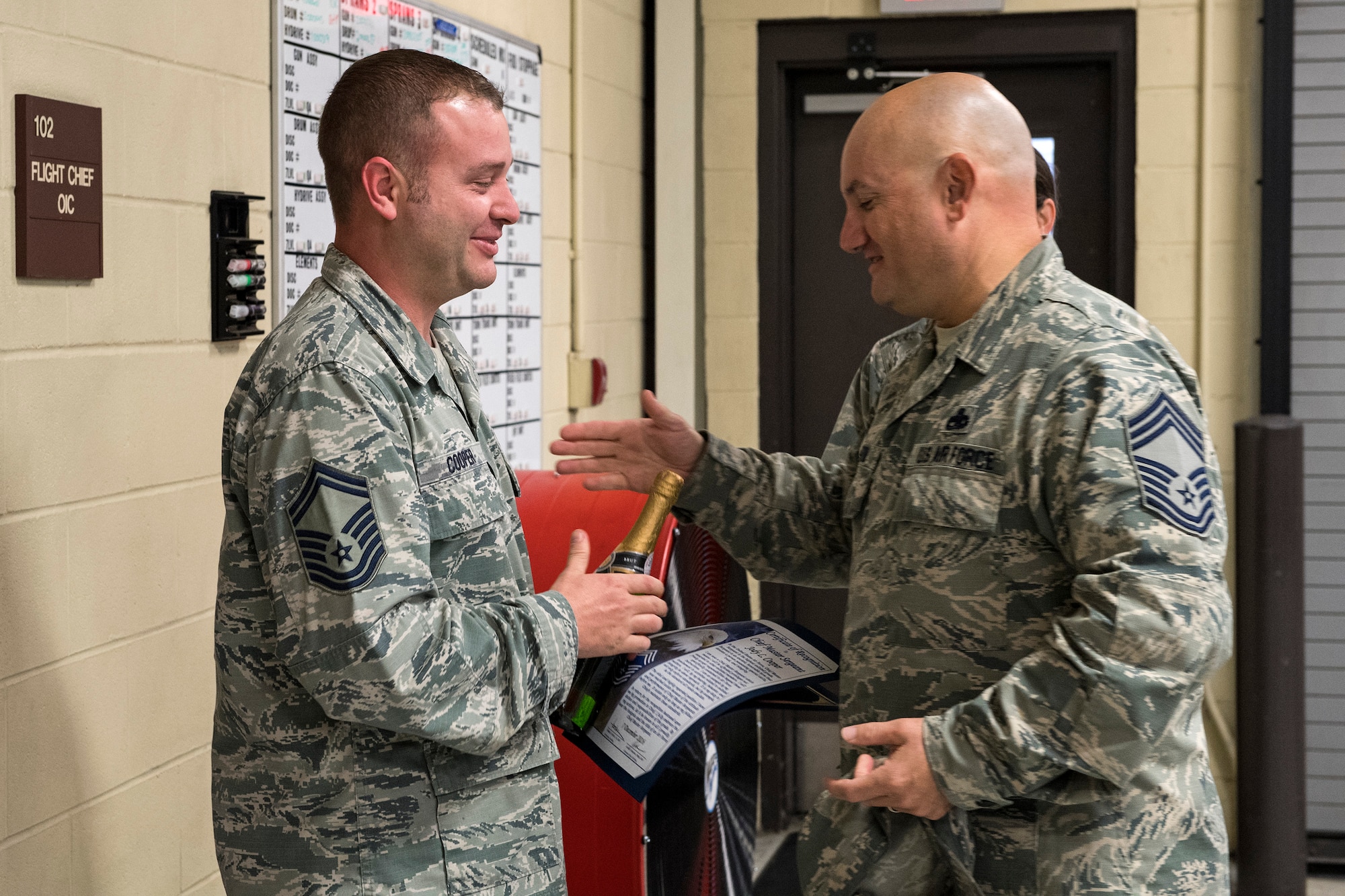 Senior Master Sgt. Jody Cooper, 23d Equipment Maintenance Squadron armament flight superintendent, shakes hands with a member of Moody’s Chiefs Group, Dec. 7, 2016, at Moody Air Force Base, Ga. Cooper is one of 11 Moody members selected for promotion to the rank. (U.S. Air Force photo by Airman 1st Class Janiqua P. Robinson)