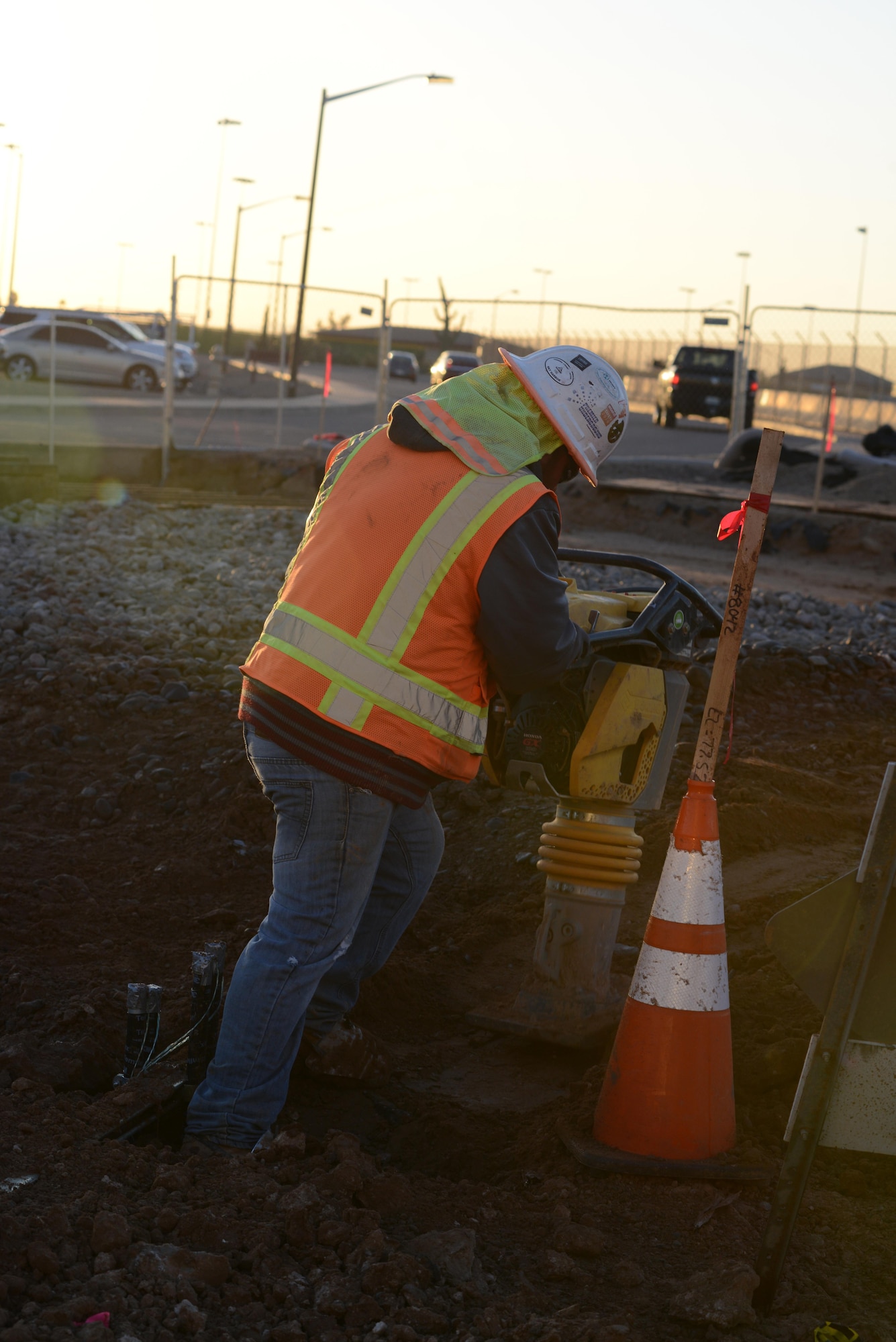 A 56th Civil Engineering Squadron general contractor uses equipment to compact dirt Dec. 8, 2016, at Luke Air Force Base, Ariz. The ground needs compacting to ensure the integrity of the building doesn’t sink or fail.   (U.S. Air Force photo by Airman 1st Class Pedro Mota)