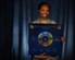 Staff Sgt. Monique McCoy, 70th Operations Support Squadron, wing mission training flight program manager, holds the board game portion of the Blue Talon training program. The mission training flight worked with a contractor to develop a program that could enable signals intelligence Airmen to gain an air operations mindset. (U.S. Air Force photo/Tech. Sgt. Veronica Pierce) 