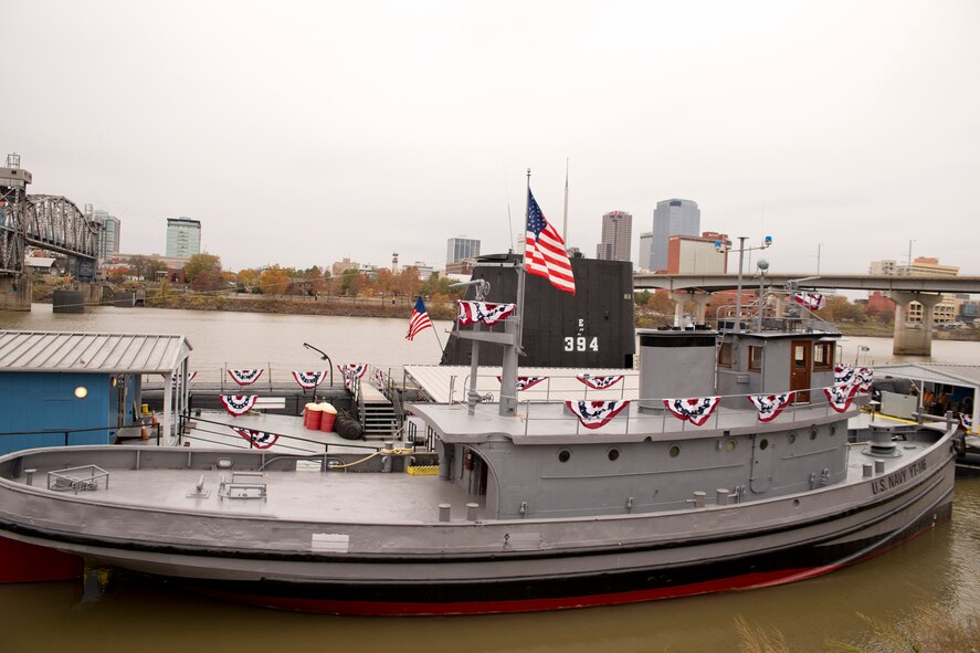 The USS Hoga (YT 146), a Woban-class district harbor tug, moored alongside the diesel submarine, USS Razorback (SS-394), at the Arkansas Inland Maritime Museum in North Little Rock, Ark., Dec. 7, 2016. Hundreds gathered in the cold at the museum for the “Arkansas Remembers Pearl Harbor Ceremony” commemorating the 75th Anniversary of the attack on Pearl Harbor. The two boats are considered by some as World War II “bookends.” The crew of the Hoga fought fires on Battleship Row for 72 continuous hours after the Japanese attack, and is the last floating Navy vessel present in Pearl Harbor during the attack, while the Razorback was present in Tokyo Bay when Japan formally surrendered to Allied Forces ending World War II. (U.S. Air Force photo by Master Sgt. Jeff Walston/Released)