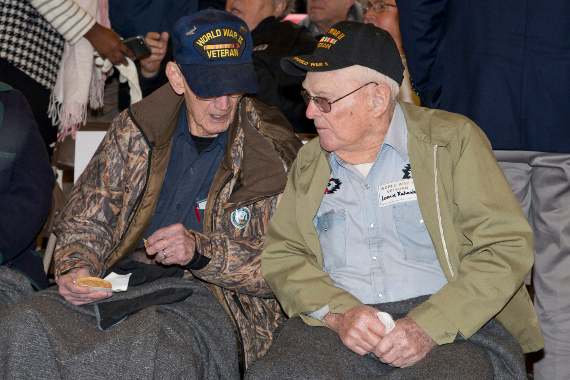 U.S. Army Corporal Lonnie Richards, (Right) who served in the South Pacific in World War II as the number one man on a 155mm Howitzer, speaks with U.S. Navy Aviation Metalsmith 2nd Class Troy Edwards, during the “Arkansas Remembers Pearl Harbor Ceremony” commemorating the 75th Anniversary of the attack on Pearl Harbor, at the Arkansas Inland Maritime Museum in North Little Rock, Ark., Dec. 7, 2016. Edwards helped set up bases and fixed aircraft during the war, saying his proudest moments were while working on U.S. Marine Corps Maj. Gregory “Pappy” Boyington’s aircraft. Both veterans call Arkansas home. (U.S. Air Force photo by Master Sgt. Jeff Walston/Released)