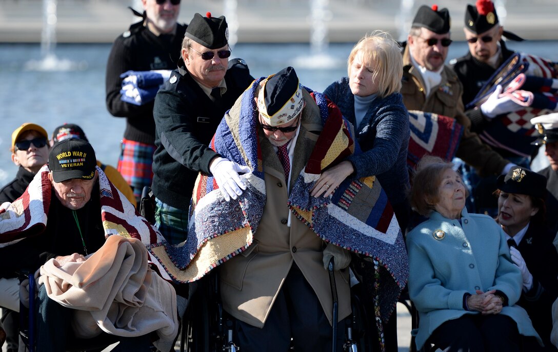 Retired Air Force Chief Warrant Officer Jay C. Groff Jr. is covered with a Quilt of Valor that was given to all the World War II veterans during the 2016 Pearl Harbor Remembrance Day 75th Anniversary Commemoration at the World War II Memorial in Washington, D.C., Dec. 7, 2016. Stationed at Hickam Field in Oahu, Hawaii, Groff heard an explosion on Dec. 7, 1941, and raced out of the barracks to defend against the attack. (U.S. Army photo/Sgt. Jose A. Torres Jr.)