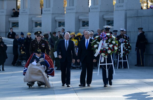 World War II veteran William Flatters, U.S. Sen. John McCain and Vice President-elect Mike Pence walk toward the location they will be laying a wreath during the 2016 Pearl Harbor Remembrance Day 75th Anniversary Commemoration at the World War II Memorial in Washington, D.C., Dec. 7, 2016. (U.S. Army photo/Sgt. Jose A. Torres Jr.)