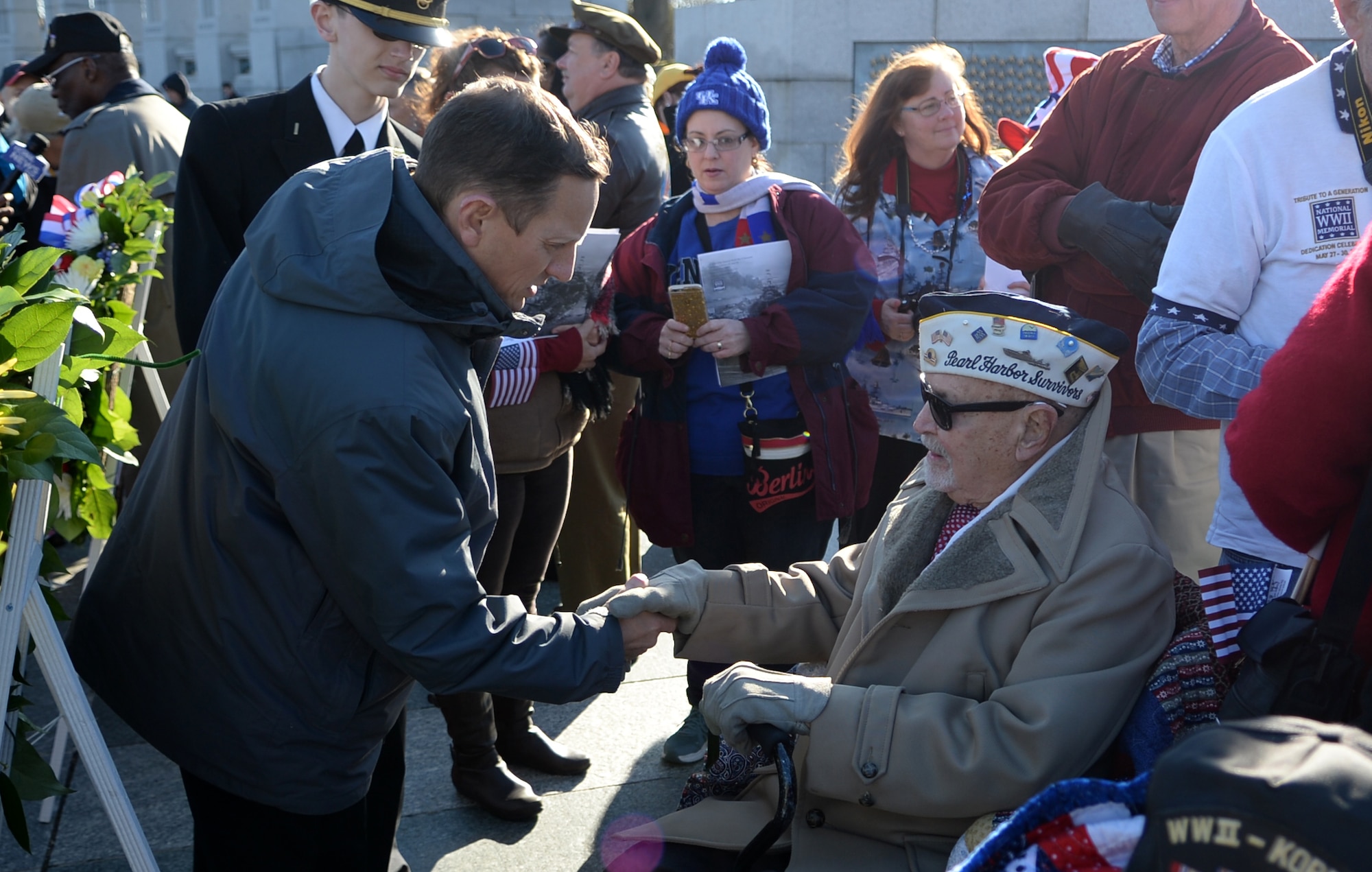 World War II veteran and retired Air Force Chief Warrant Officer Jay C. Groff Jr. is greeted and surrounded by attendees of the 2016 Pearl Harbor Remembrance Day 75th Anniversary Commemoration at the World War II Memorial in Washington, D.C., Dec. 7, 2016. (U.S. Army photo/Sgt. Jose A. Torres Jr.)