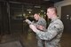 Air Force Sustainment Center Command Chief Master Sgt. Gary S. Sharp holds an M4 rifle while Senior Airman James Brewer, 72nd Logistics Readiness Squadron weapons custodian, provides guidance on how to properly line-up the laser sight during a mission and capabilities immersion tour with the 72nd Air Base Wing Dec. 7, 2016, Tinker Air Force Base, Okla. During his visit to the 72nd ABW CMSgt. Sharp learned about high-profile shops like finance and the ID card section while also learning about the lesser known shops like the mobility weapons vault operated by the 72nd LRS. (U.S. Air Force photo/Greg L. Davis)