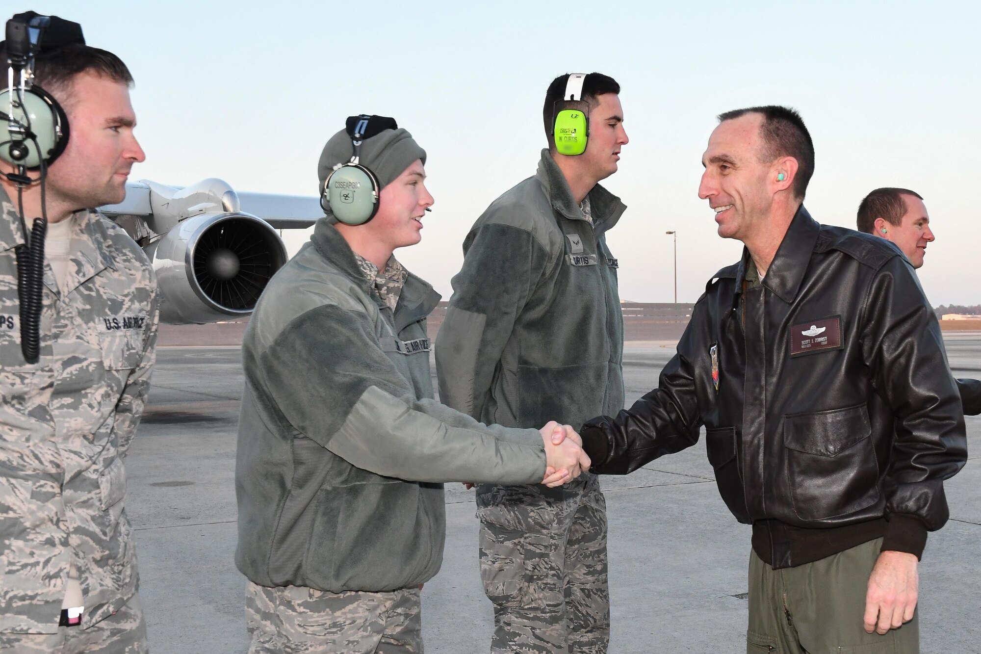 U.S. Air Force Maj. Gen. Scott J. Zobrist, 9th Air Force commander, and Chief Master Sgt. Frank H. Batten III, 9th AF command chief, visit with the Joint Surveillance Target Attack Radar System, or JSTARS, team at Robins Air Force Base, Ga., to learn more about its mission and capabilities, Dec. 8, 2016.  During the visit, Zobrist and Batten met with Team JSTARS leadership and Airmen and flew a mission aboard the E-8C Joint STARS, manned airborne battle management, command and control, intelligence, surveillance and reconnaissance platform. (U.S. Air National Guard photo by Senior Master Sgt. Roger Parsons) (Portion of aircraft maintainer's ear defender blurred for security purposes)