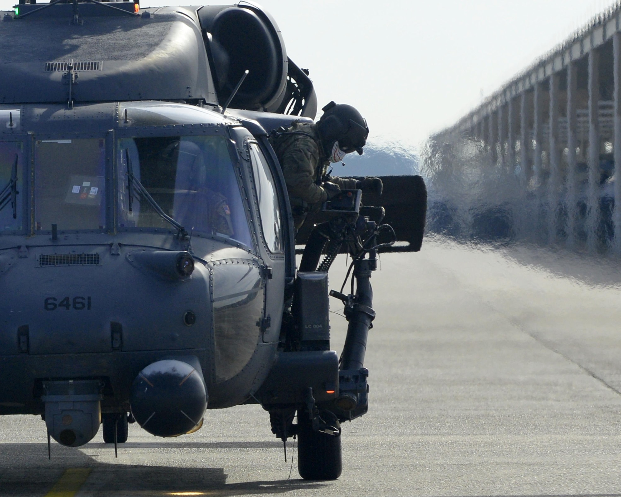 A U.S. Air Force 66th Rescue Squadron HH-60G Pave Hawk aircrew member makes final adjustments before takeoff during the Checkered Flag 17-1 exercise at Tyndall Air Force Base, Fla., Dec. 8, 2016. Checkered Flag exercises focus on large scale total force integration which is designed to be rapid responses to unforeseen or unplanned operations. Which is indicative of the Air Force competency of air and space superiority. The 66th Rescue Squadron operates out of Nellis Air Force Base, Nevada. (U.S. Air Force photo by Airman 1st Class Cody R. Miller/Released)