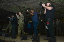 U.S. Army Soldiers operate Engagement Skills Trainer weapons with Brian Garcia, left, MMAjunkie radio host, Lorenz Larkin, center, UFC welterweight fighter, and Ben Rothwell, right, UFC heavyweight fighter, at Joint Base Langley-Eustis, Va., Dec. 8, 2016. The group also met with U.S. Army Soldiers from the 7th Transportation Brigade (Expeditionary) and 690th Rapid Port Opening Element to discuss their various missions.  (U.S. Air Force photo by Tech. Sgt. Katie Gar Ward)