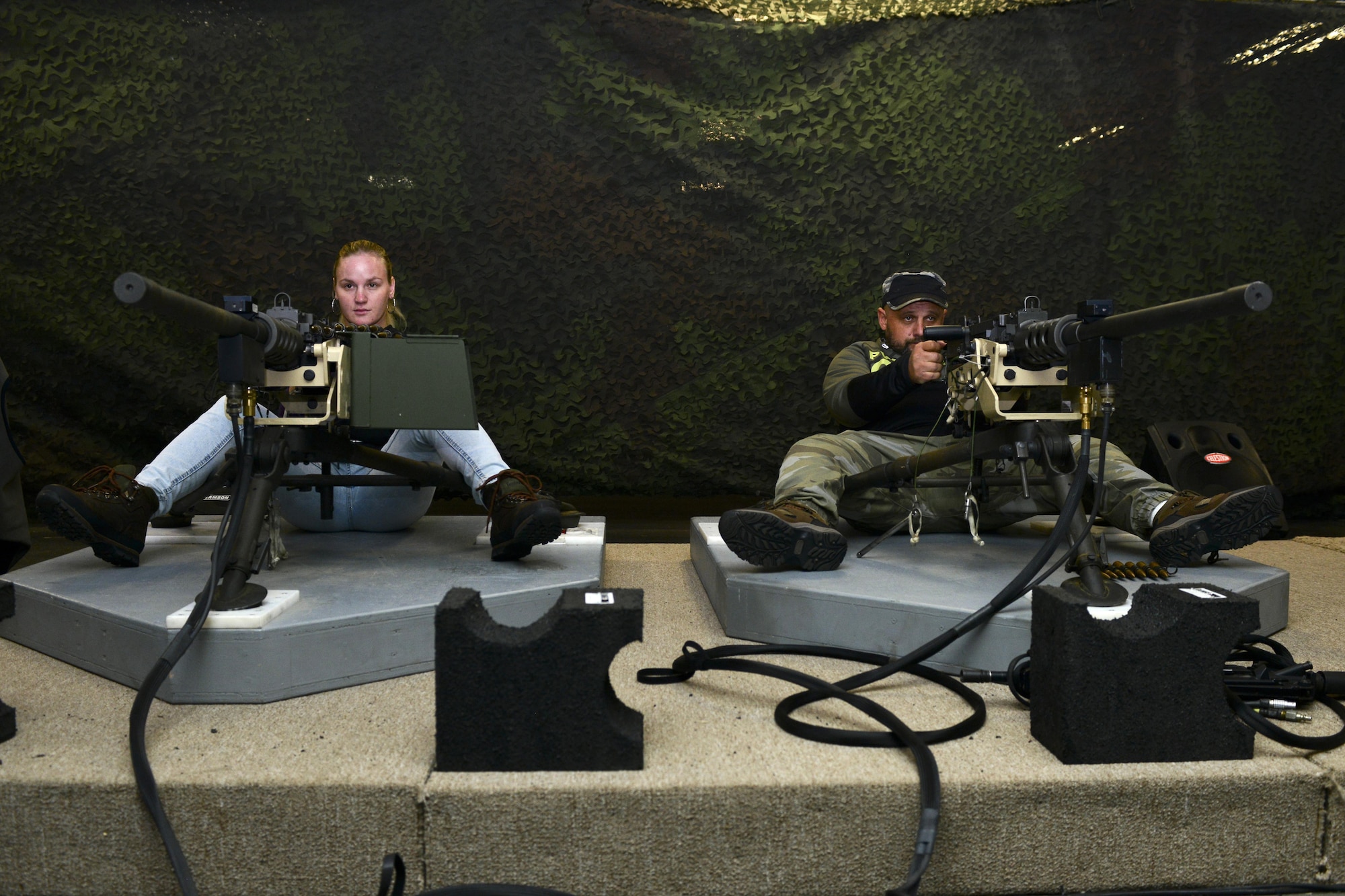 Valentina Shevchenko, UFC bantamweight fighter, and her coach, Pavel Fedotov, operate Engagement Skills Trainer weapons during a visit to Joint Base Langley-Eustis, Va., Dec. 8, 2016. Shevchenko, originally from Bishkek, Kyrgyzstan, said she has been practicing martial arts since she was 5 years old.  (U.S. Air Force photo by Tech. Sgt. Katie Gar Ward)