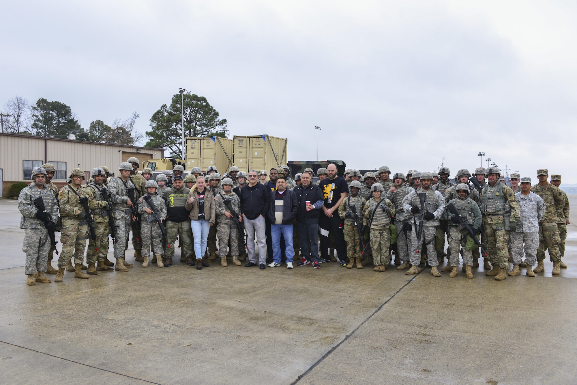 UFC fighters Ben Rothwell, Valentina Shevchenko, and Lorenz Larkin pose for a photo with U.S. Army Soldiers from the 7th Transportation Brigade (Expeditionary) at Joint Base Langley-Eustis, Va., Dec. 8, 2016. The fighters met with the Soldiers to discuss their daily operations and to thank them for their dedication. (U.S. Air Force photo by Tech. Sgt. Katie Gar Ward)