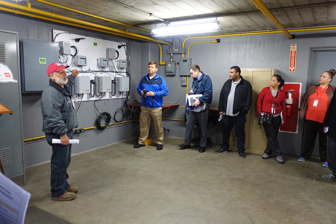 LA Unified School District and STEM Academy educators and administrators took a field trip to the Whittier Narrows Dam on Dec. 6.  Dam operations supervisor Louie Munoz (far left), escorted visitors through the dam to the machinery used to lower and raise the flood control gates. U.S. Army Corps of Engineer Los Angeles District, which operates and maintains the dam, promotes STEM by hosting visits to their sites.