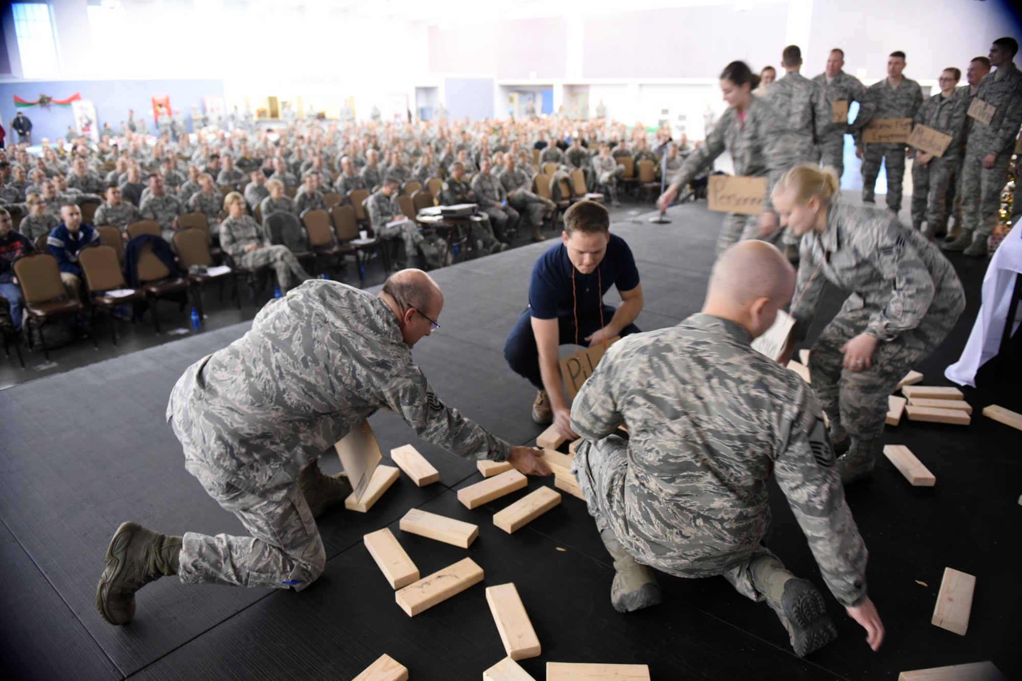 Chief Master Sgt. Pat Halko lends a hand to Guardsmen during a skit performed during the 120th Airlift Wing’s Wingman Day event December 3, 2016 at the Mansfield Center in Great Falls, Montana. The skit demonstrated the appropriate utilization of Guardsmen.  (U.S. Air National Guard photo/Master Sgt. Michael Touchette) 
