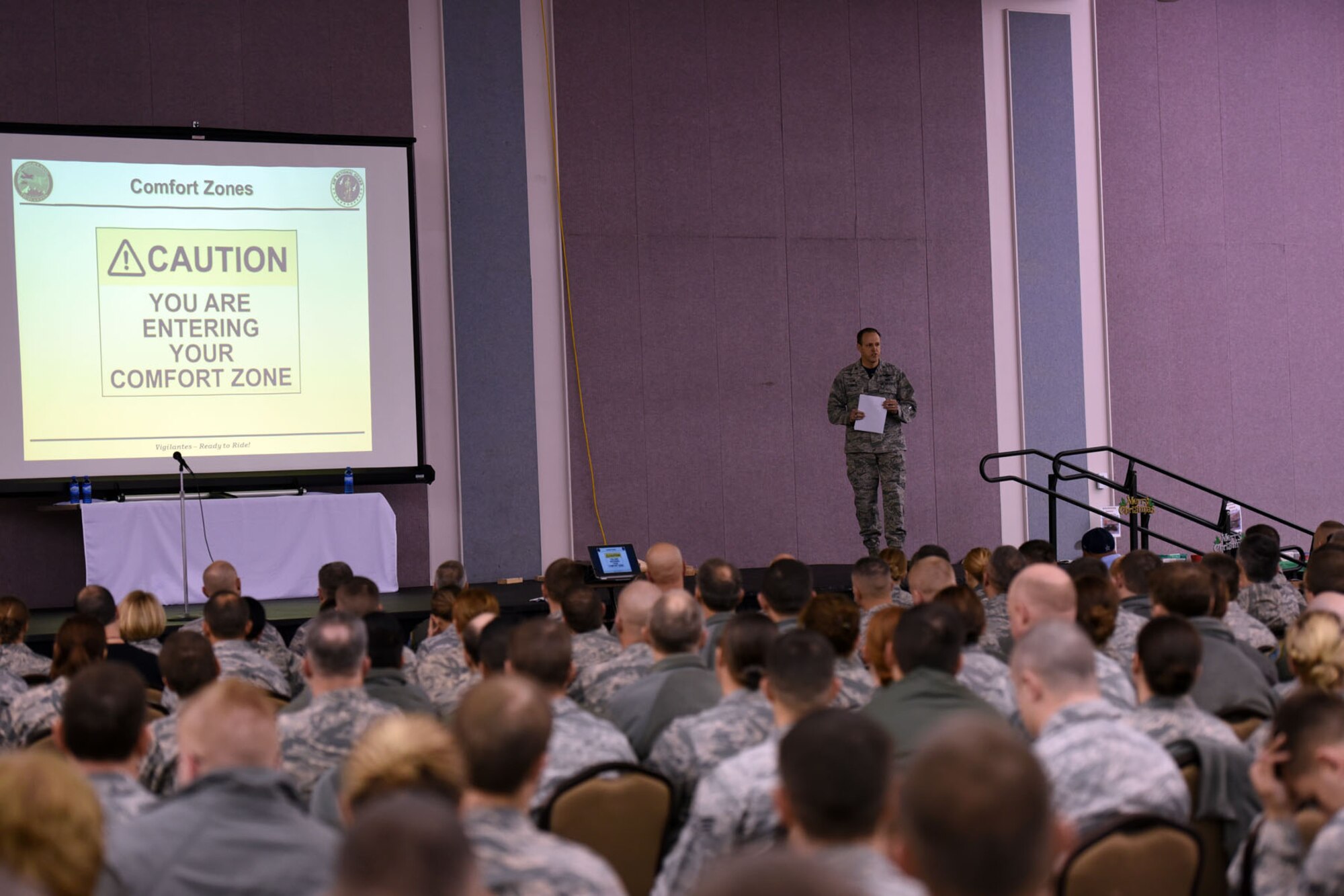 120th Airlift Wing Commander Col. Lee Smith speaks to nearly 500 Airmen in attendance at the unit’s annual Wingman Day, December 3, 2016 at the Mansfield Center in Great Falls, Mont. Smith’s message encouraged Airmen to step outside their comfort zones. (U.S. Air National Guard photo/Master Sgt. Michael Touchette)