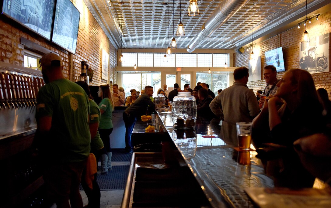 Goldsboro Brew Works, a veteran owned company, celebrates its grand opening, Dec. 2, 2016, in Downtown Goldsboro, North Carolina. Clark and Fein, former F-15E Strike Eagle crew chiefs at Seymour Johnson Air Force Base, began the renovation process for their business by building the bar and tables from scratch. (U.S. Air Force photo by Airman Miranda A. Loera)