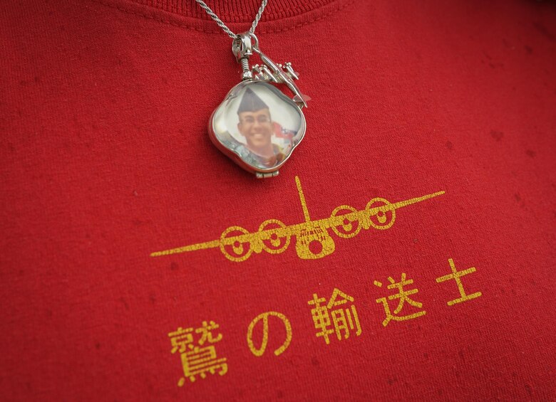 Eva Hake wears a pendant memorializing her late son, Senior Airman Jeremy Jutba-Hake, 36th Airlift Squadron instructor loadmaster, at Andersen Air Force Base, Guam, Dec. 6, 2016. The pendant was a gift given to her on behalf of his fellow Airmen from his squadron commander after Jutba-Hake passed away during Operation Christmas Drop 2015. On day two of OCD 2016, Jutba-Hake’s colleagues, friends and family gathered for a remembrance ceremony before beginning the day’s mission. (U.S. Air Force photo by Senior Airman Elizabeth Baker/Released)