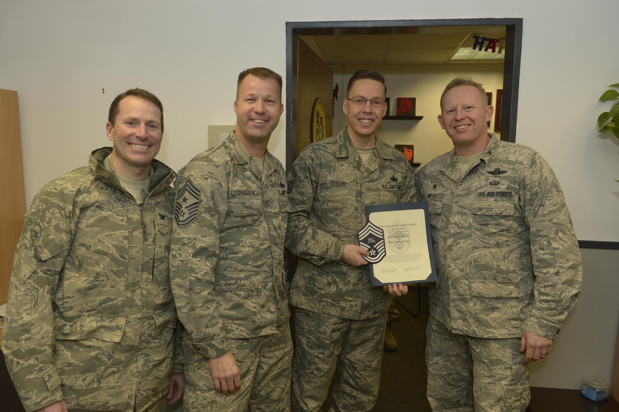 Senior Master Sgt. Ryan Strub, center right, 52nd Logistic Readiness Squadron fuels management flight superintendent, receives notification he has been selected for promotion to chief master sergeant from Col. Joe McFall, right, 52nd Fighter Wing commander, Col. Steven Horton, left, 52FW vice commander, and Chief Master Sgt. Edwin Ludwigsen, center left, 52FW command chief, at Spangdahlem Air Base, Germany, Dec. 7, 2016. The
selected senior master sergeant will later be inducted into the top one percent of the Air Force's enlisted ranks. (U.S. Air Force photo by Staff Sgt. Jonathan Snyder)