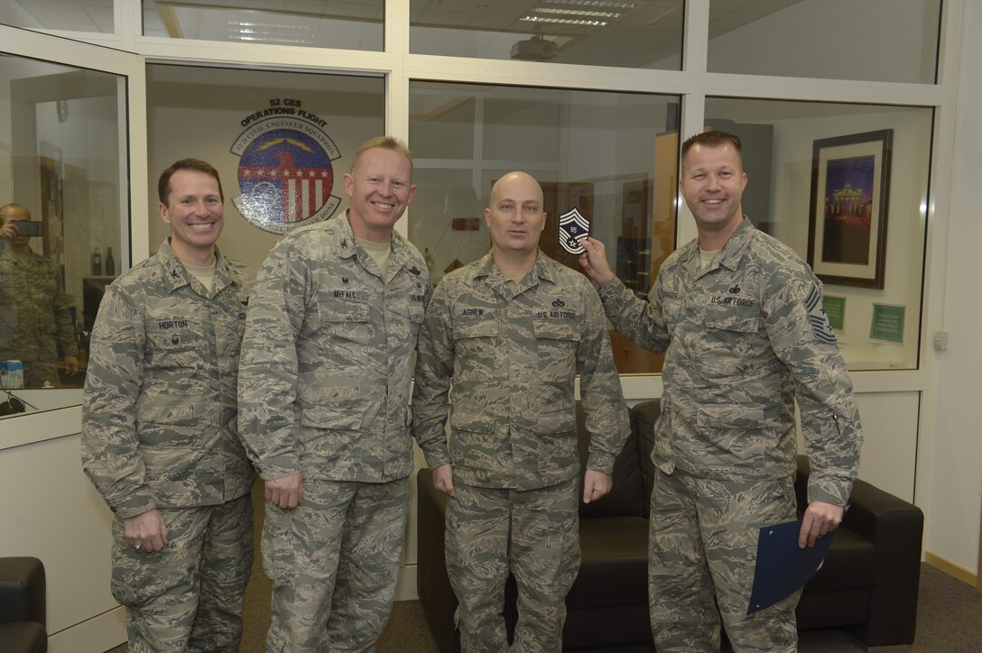 Senior Master Sgt. John Agnew, center right, 52nd Civil Engineer Squadron facility systems superintendent, receives notification he has been selected for promotion to chief master sergeant from Col. Joe McFall, center left, 52nd Fighter Wing commander, Col. Steven Horton, left, 52FW vice commander, and Chief Master Sgt. Edwin Ludwigsen, right, 52FW command chief, at Spangdahlem Air Base, Germany, Dec. 7, 2016. The selected senior master sergeant will later be inducted into the top one percent of the Air Force's enlisted ranks. (U.S. Air Force photo by Staff Sgt. Jonathan Snyder)