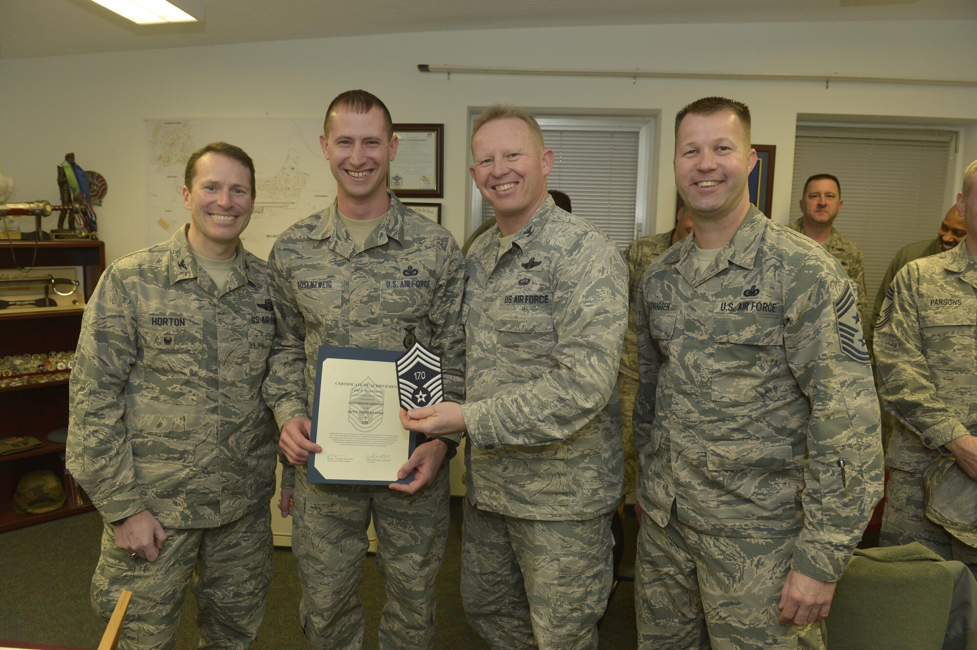 Senior Master Sgt. Todd Rosenzweig, center left, 52nd Security Forces Squadron superintendent, receives notification he has been selected for promotion to chief master sergeant from Col. Joe McFall, center right, 52nd
Fighter Wing commander, Col. Steven Horton, left, 52FW vice commander, and Chief Master Sgt. Edwin Ludwigsen, right, 52FW command chief, at Spangdahlem Air Base, Germany, Dec. 7, 2016. The selected senior master sergeant will later be inducted into the top one percent of the Air Force's enlisted ranks. (U.S. Air Force photo by
Staff Sgt. Jonathan Snyder)