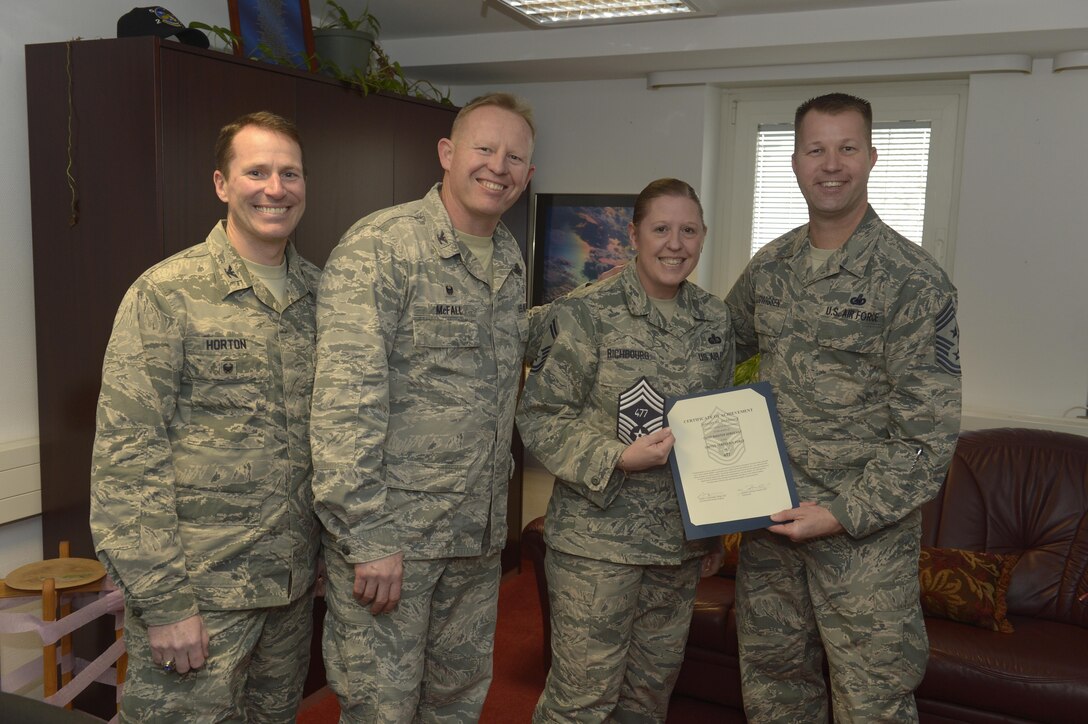 Senior Master Sgt. Jennifer Richbourg, center right, 52nd Force Support Squadron sustainment services superintendent, receives notification she has been selected for promotion to chief master sergeant from Col. Joe
McFall, center left, 52nd Fighter Wing commander, Col. Steven Horton, left, 52FW vice commander, and Chief Master Sgt. Edwin Ludwigsen, right, 52FW command chief, at Spangdahlem Air Base, Germany, Dec. 7, 2016. The selected senior master sergeant will later be inducted into the top one percent of the Air Force's enlisted ranks. (U.S. Air Force photo by Staff Sgt. Jonathan Snyder)