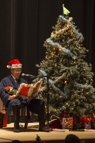 Jeffrey Carr, Matthew C. Perry High School assistant principal, narrates as the symphonic band plays “The Night Before Christmas” during the annual holiday celebration concert at the Sakura Assembly Hall at Marine Corps Air Station Iwakuni, Japan, Dec. 7, 2016. The concert showcased various musical groups from M.C. Perry and brought base residents, students and staff from Suo-Oshima Municipal Elementary School, Waki Junior High School and Otake Municipal Ogata Junior High School together. To start the concert, the symphonic band played “Angels We Have Heard on High” to approximately 300 guests inside the theater. (U.S. Marine Corps photo by Cpl. Aaron Henson)