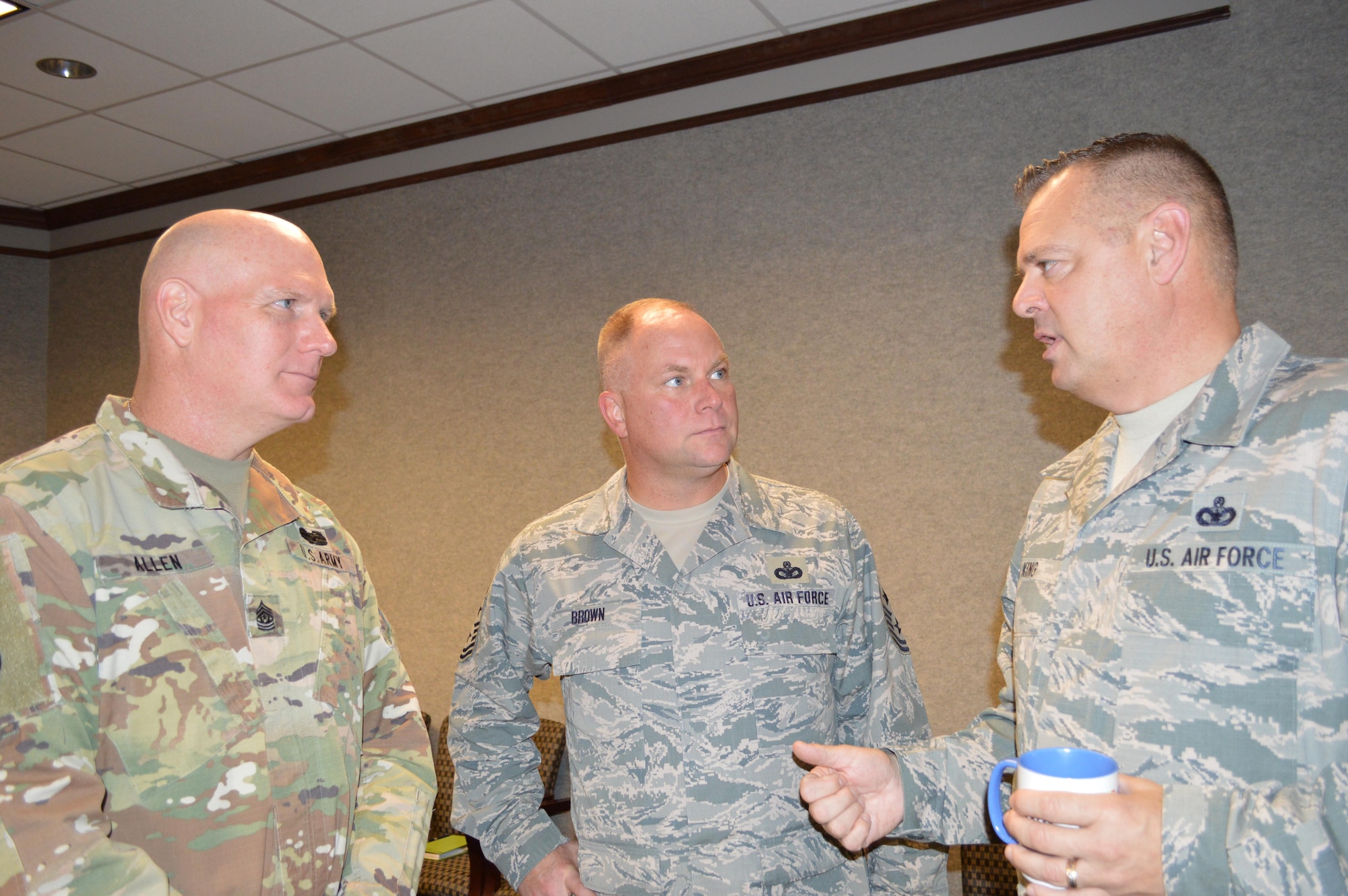(From left) West Virginia Army National Guard Command Sergeant Maj. James Allen and Air National Guard Enlisted Force Advisory Council Chairman and Kansas National Guard Senior Enlisted Leader, Chief Master Sgt. James Brown, listen to a point by Chief Master Sgt. Richard King, Continental U.S. Aerospace Defense Region-1st Air Force (AFNORTH) Command Chief, during the Enlisted Force Advisory Council Meeting at Tyndall Air Force Base, Fla., Dec. 6-7. It was the first time a command sergeant major attended the Air National Guard EFAC event as it was determined similar issues for enlisted forces existed across both armed service brances. Brown will attend the next Army Command Sergeant Major Advisory Council meeting. (Photo by Mary McHale)