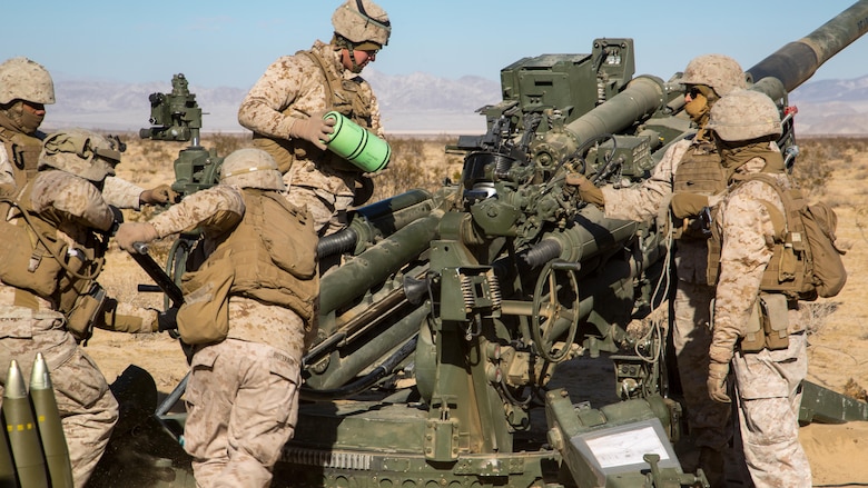 Marines with Battery K, 3rd Battalion, 11th Marine Regiment, prepare an M777A2 Howitzer to fire in the Acorn Training Area aboard the Marine Corps Air Ground Combat Center, Twentynine Palms, Calif., Dec. 2, 2016, during the regiment’s “Top Gun” competition.