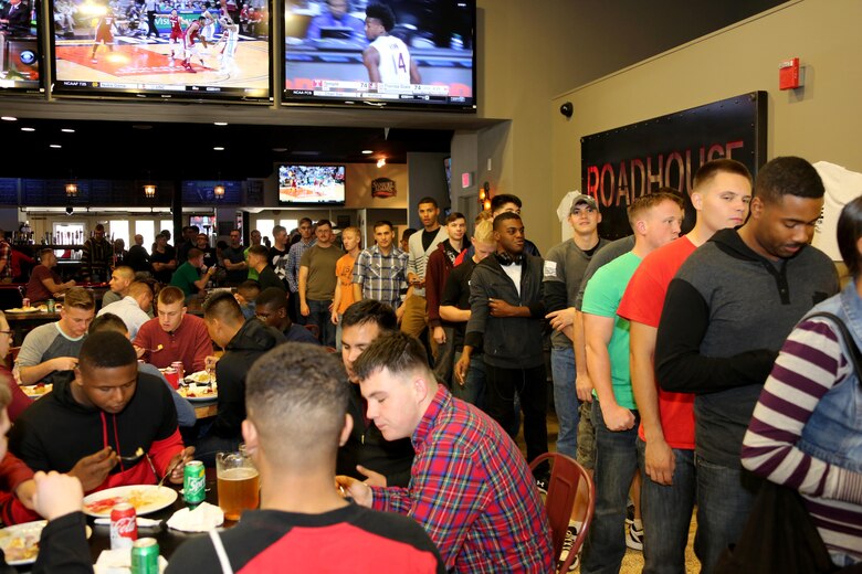 Marines wait in line for food during the Single Marine Program’s annual Thanksgiving Dinner at Marine Corps Air Station Cherry Point, N.C., Nov. 24, 2016. The Cherry Point Officers’ Spouse’s club and Enlisted Spouses Club of MCAS Cherry Point sponsored the event which distributed over six-hundred plates of food. Volunteers from Marine Corps Community Services and the Marine Corps League served Marines and their family members a full-course meal and desserts. (Marine Corps photo by Cpl. Jason Jimenez/Released)