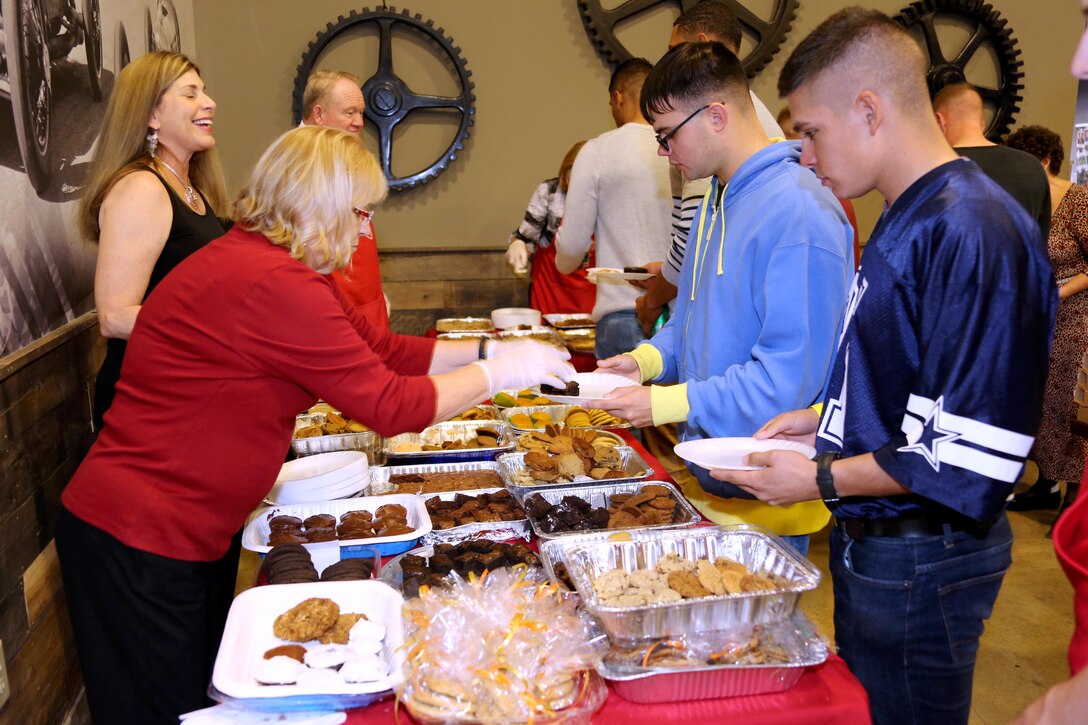 A volunteer serves Marines dessert during the Single Marine Program’s annual Thanksgiving Dinner at Marine Corps Air Station Cherry Point, N.C., Nov. 24, 2016. The Cherry Point Officers’ Spouse’s club and Enlisted Spouses Club of MCAS Cherry Point sponsored the event which distributed over six-hundred plates of food. Volunteers from Marine Corps Community Services and the Marine Corps League served Marines and their family members a full-course meal and desserts. (Marine Corps photo by Cpl. Jason Jimenez/Released)