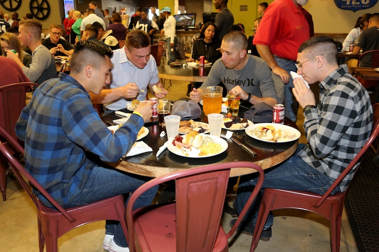 Marines feast on a full-course meal during the Single Marine Program’s annual Thanksgiving Dinner at Marine Corps Air Station Cherry Point, N.C., Nov. 24, 2016. The Cherry Point Officers’ Spouse’s club and Enlisted Spouses Club of MCAS Cherry Point sponsored the event which distributed over six-hundred plates of food. Volunteers from Marine Corps Community Services and the Marine Corps League served Marines and their family members a full-course meal and desserts. (Marine Corps photo by Cpl. Jason Jimenez/Released)