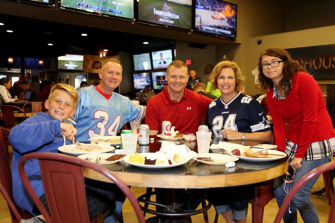 Col. Todd Ferry, second from left, poses for a photo with his children, alongside Col. and Mrs. John Rahe Jr., center, during the Single Marine Program’s annual Thanksgiving Dinner at Marine Corps Air Station Cherry Point, N.C., Nov. 24, 2016. The Cherry Point Officers’ Spouse’s club and Enlisted Spouses Club of MCAS Cherry Point sponsored the event which distributed over six-hundred plates of food. Volunteers from Marine Corps Community Services and the Marine Corps League served Marines and their family members a full-course meal and desserts. Ferry is the commanding officer of MCAS Cherry Point and Rahe is the assistant wing commander with the 2nd Marine Aircraft Wing. (Marine Corps photo by Cpl. Jason Jimenez/Released)