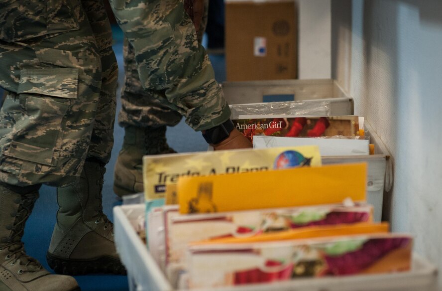 An Airman volunteering at the Northside Post Office sifts through a box of mail before putting it in their corresponding mail boxes at Ramstein Air Base, Germany, Dec. 8, 2016. Volunteers can help make a difference in the community and aid in maintaining morale through dozens of volunteer opportunities during the holiday season. (U.S. Air Force photo by Airman 1st Class Lane T. Plummer)