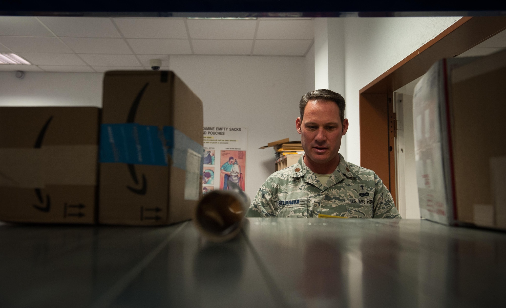 Maj. Chuck Seligman, 86th Airlift Wing chapel branch chief, helps postal specialists at the Northside Post Office at Ramstein Air Base, Germany, Dec. 8, 2016. Volunteer opportunities arise across the Kaiserslautern Military Community constantly, and some venues to reach out to the local communities in need are the United Service Organizations, located at the Ramstein Passenger Terminal, or the chapel.  (U.S. Air Force photo by Airman 1st Class Lane T. Plummer)